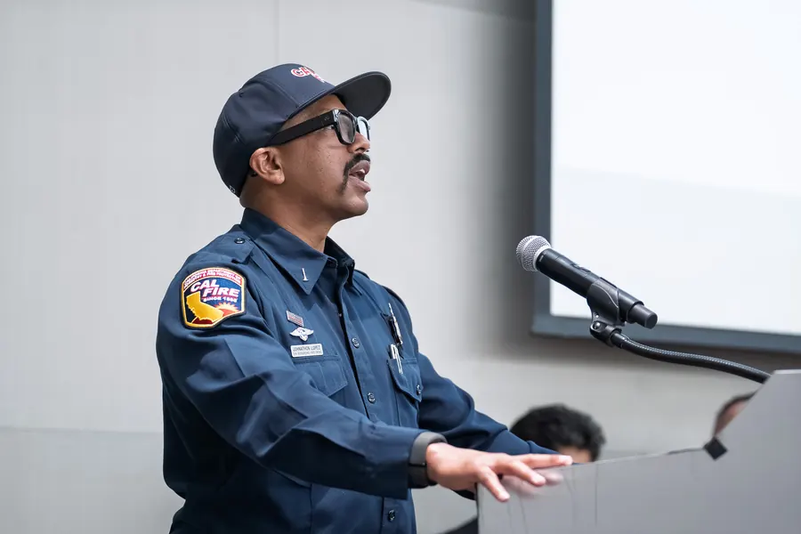 Fire service officer speaking at a podium during an event